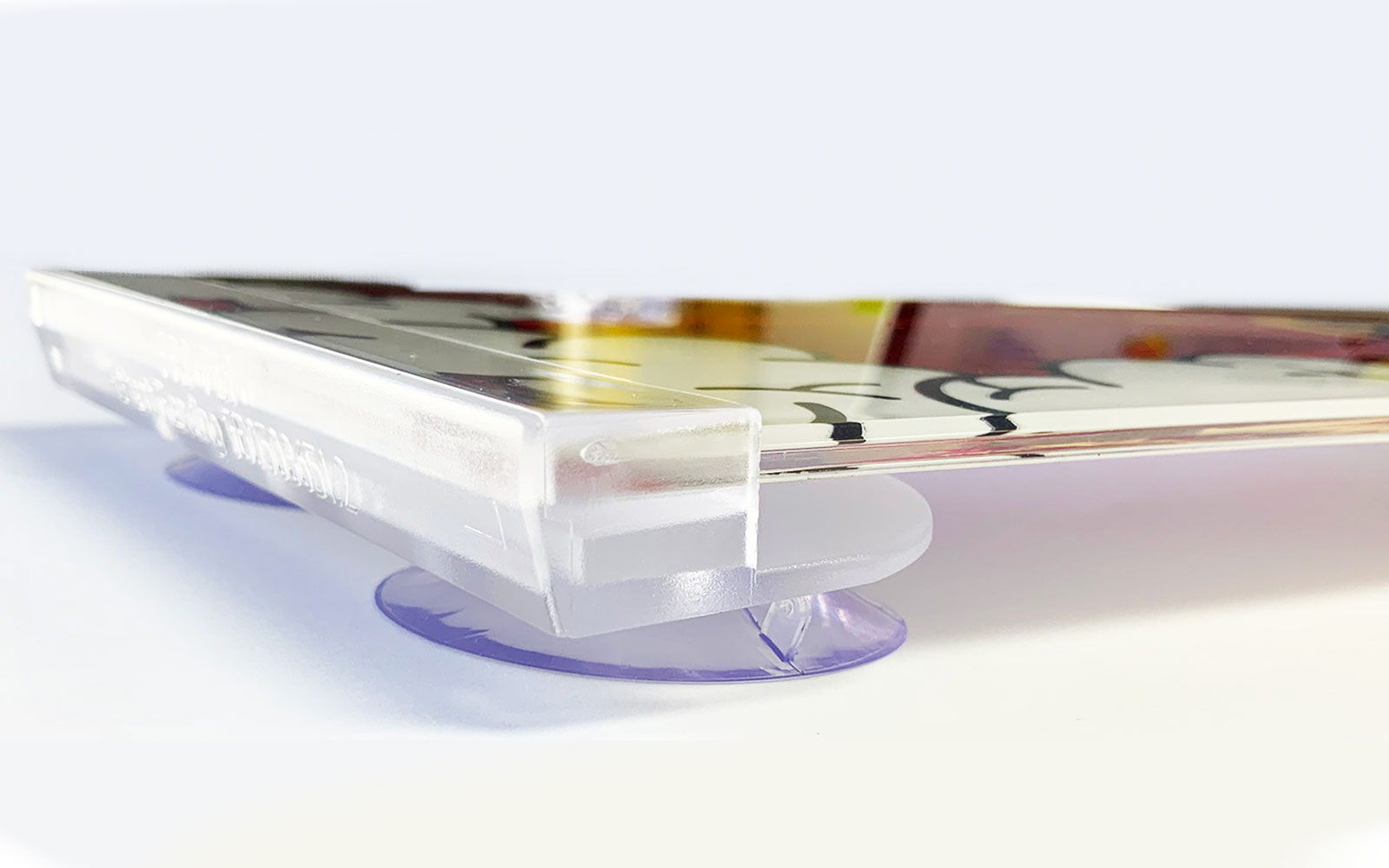 Clear acrylic show plate holder on suction cups, holding a printed plate