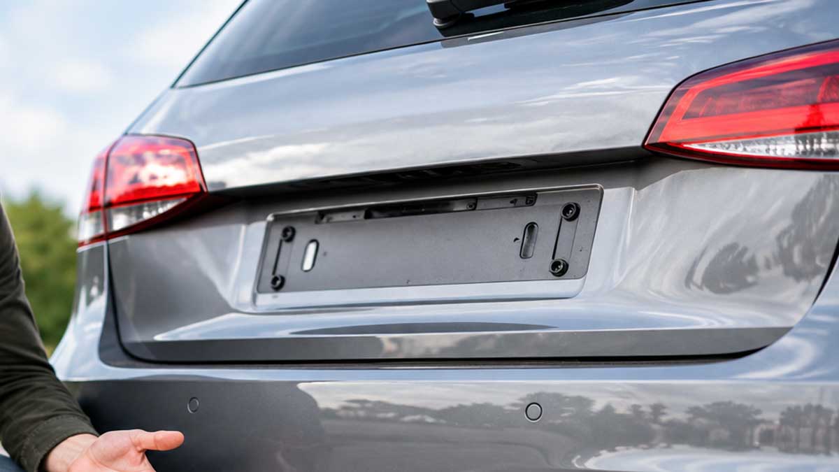 The rear of a grey hatchback with an empty number plate mount
