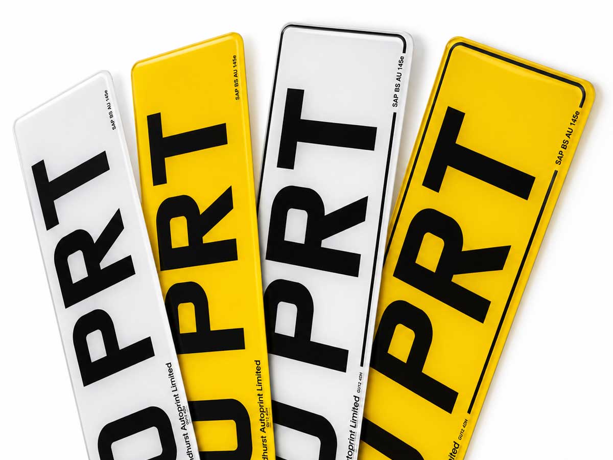 Four compliant plates fanned out, white and yellow, with and without borders