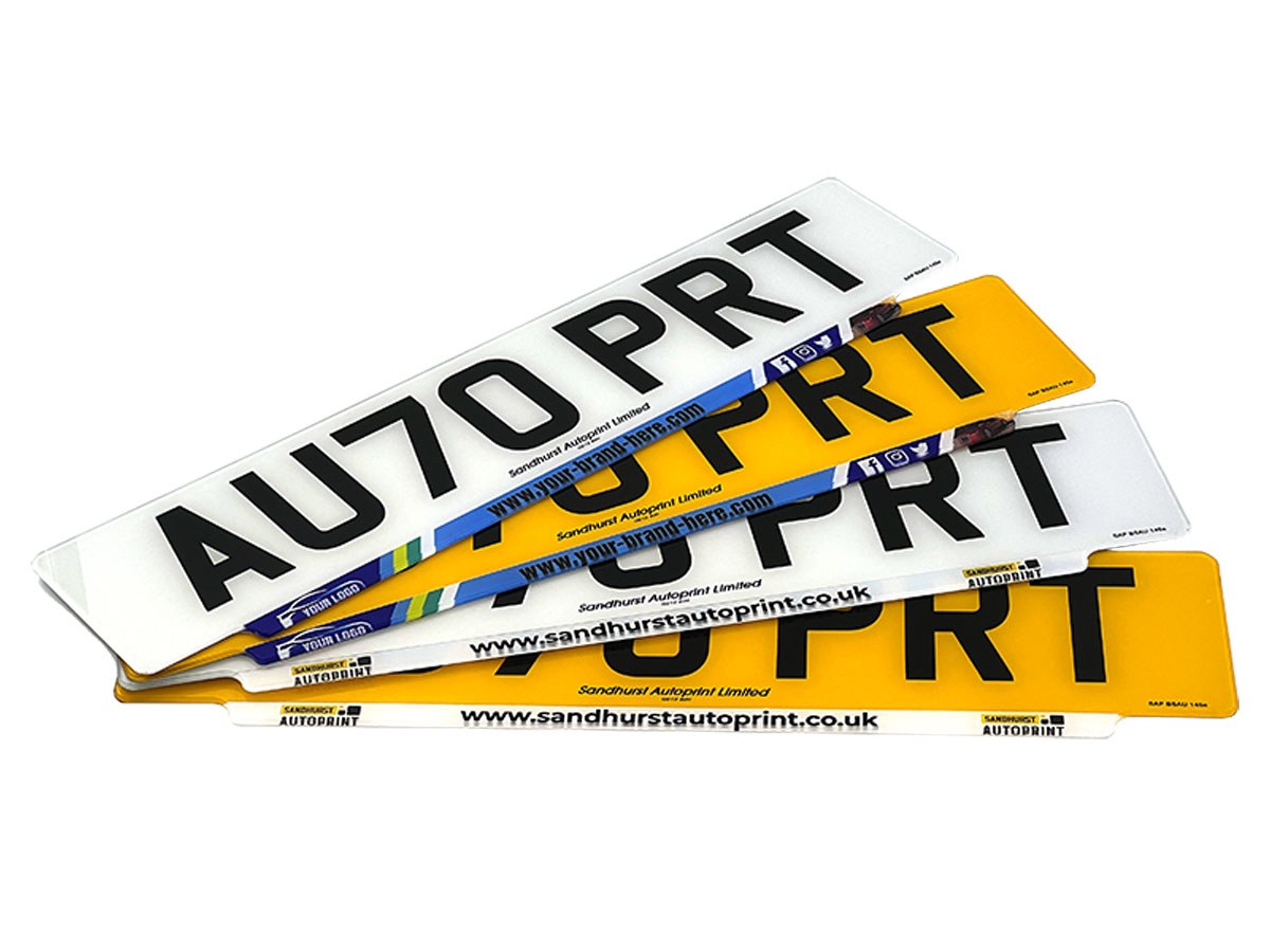 A fan of lipped number plates with printed trade branding along the lip